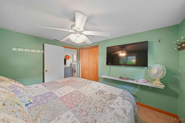 bedroom with a closet, carpet floors, baseboards, a textured ceiling, and a ceiling fan