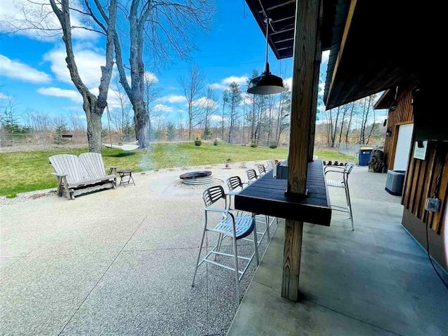 view of patio / terrace with an outdoor fire pit and cooling unit