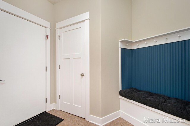 8821 Summerset Woods Ct SE, Alto, MI 49302 - mudroom with light tile patterned floors and baseboards
