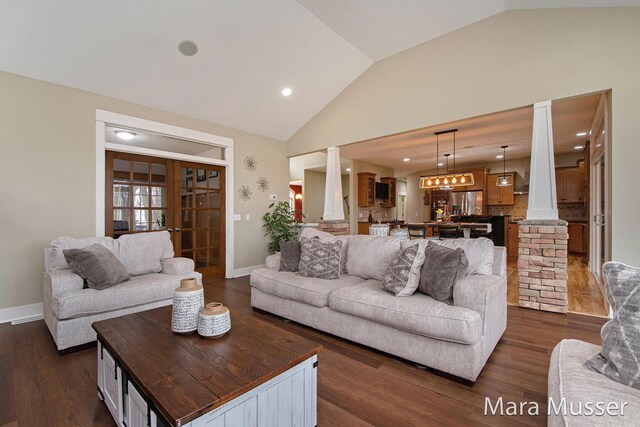 8821 Summerset Woods Ct SE, Alto, MI 49302 - living room with ornate columns, lofted ceiling, dark wood-style floors, baseboards, and recessed lighting
