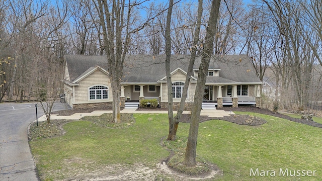 8821 Summerset Woods Ct SE, Alto, MI 49302 - view of front of home featuring a porch, a shingled roof, and a front yard