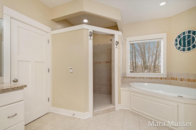 8821 Summerset Woods Ct SE, Alto, MI 49302 - full bathroom with tile patterned flooring, a shower stall, a bath, and recessed lighting