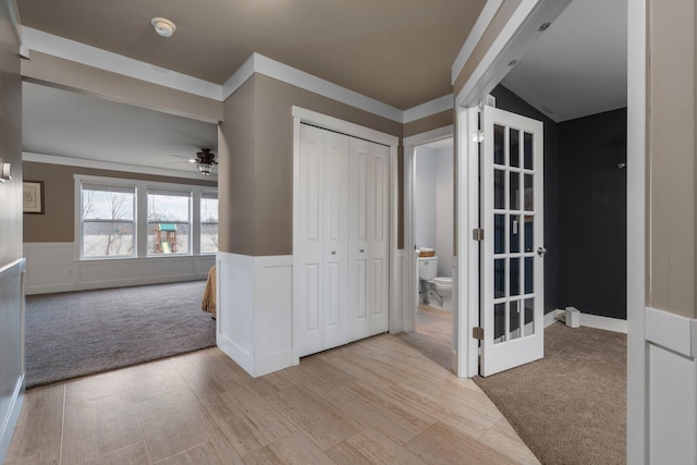 interior space with carpet and wainscoting
