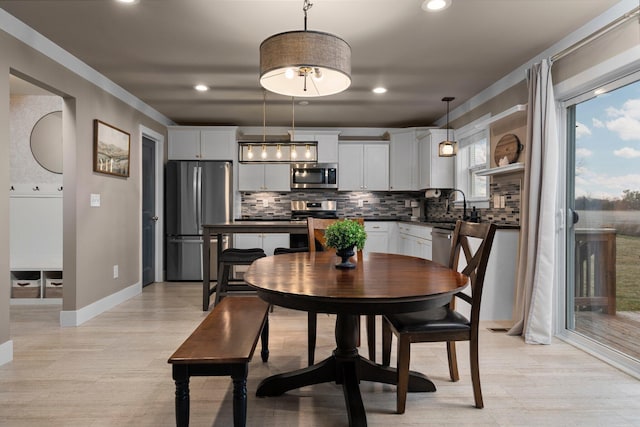 dining space with baseboards and recessed lighting