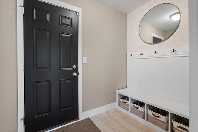 mudroom featuring baseboards and wood finished floors