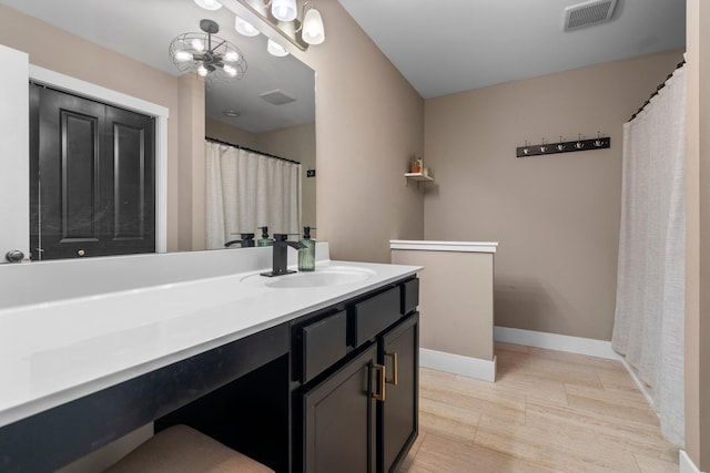 bathroom with vanity, baseboards, and visible vents