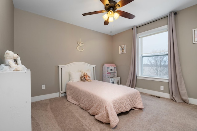 carpeted bedroom featuring baseboards, visible vents, and a ceiling fan