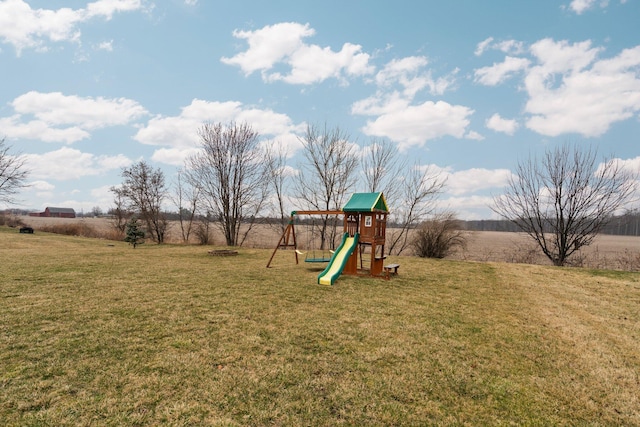 community playground featuring a rural view and a lawn