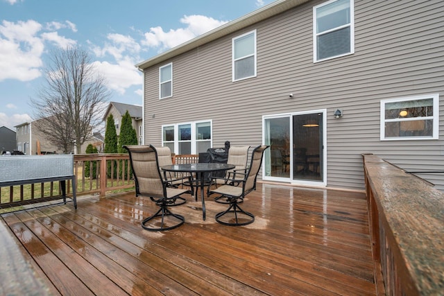 wooden terrace featuring outdoor dining space