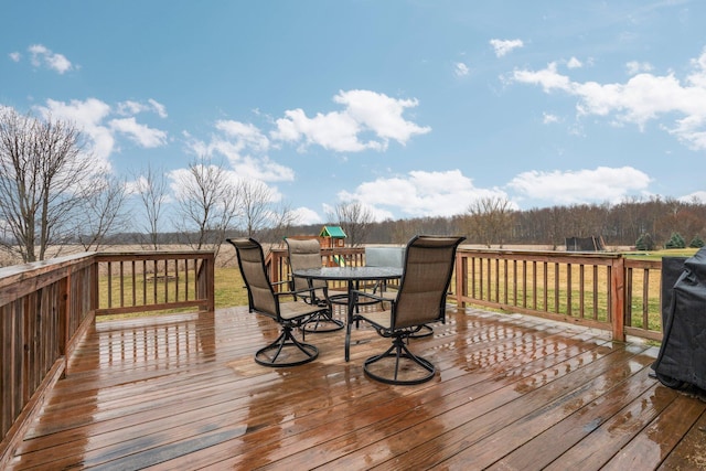 wooden terrace featuring outdoor dining area