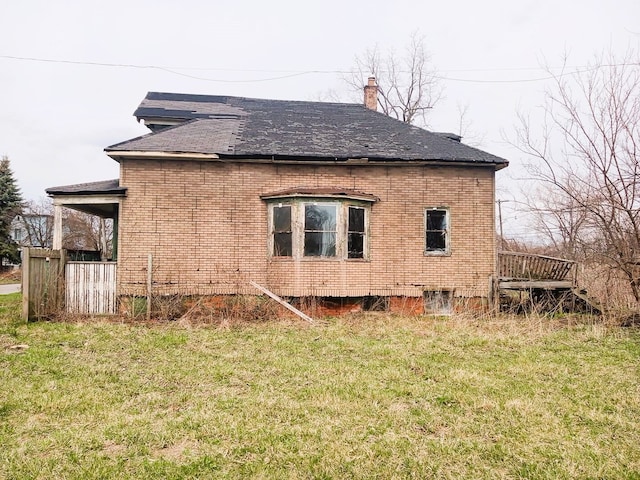 6050 Vermont St, Detroit, MI 48208 - view of home's exterior with a yard, brick siding, and a chimney