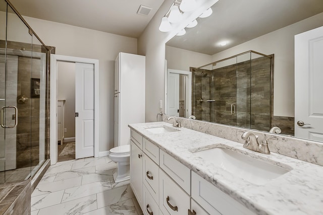 2667 Oxford Cir, Ann Arbor, MI 48103 - bathroom featuring a shower stall, marble look tiles, double vanity, and toilet