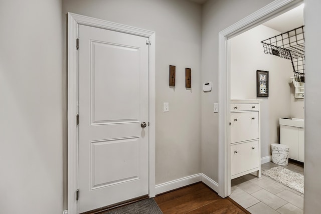 2667 Oxford Cir, Ann Arbor, MI 48103 - doorway featuring baseboards and wood finished floors