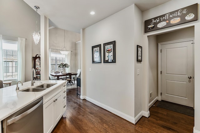 2667 Oxford Cir, Ann Arbor, MI 48103 - kitchen featuring dishwasher, a sink, dark wood-style floors, a chandelier, and white cabinetry