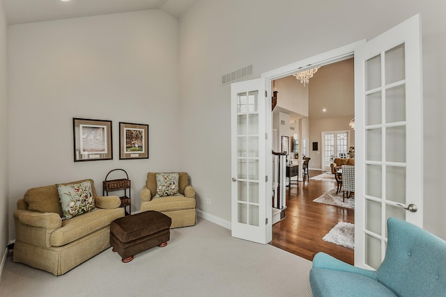 2667 Oxford Cir, Ann Arbor, MI 48103 - sitting room with french doors, high vaulted ceiling, baseboards, and a chandelier