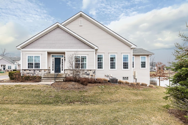 2667 Oxford Cir, Ann Arbor, MI 48103 - view of front facade featuring a front lawn, central AC unit, and stone siding