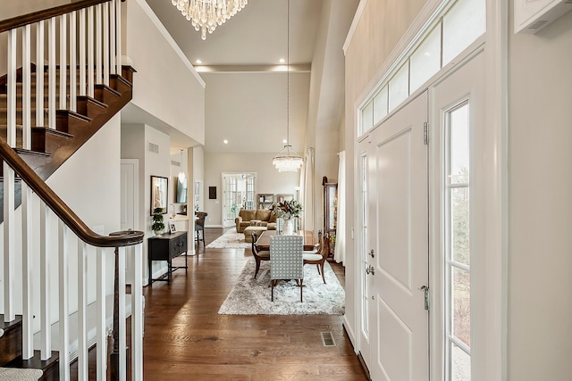 2667 Oxford Cir, Ann Arbor, MI 48103 - entrance foyer with a chandelier, a towering ceiling, stairs, dark wood-style flooring, and baseboards