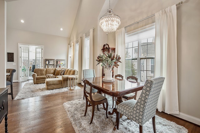 2667 Oxford Cir, Ann Arbor, MI 48103 - dining room with plenty of natural light, a chandelier, high vaulted ceiling, wood finished floors, and baseboards