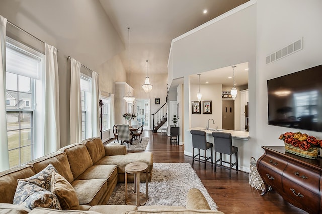 2667 Oxford Cir, Ann Arbor, MI 48103 - living room with a high ceiling, dark wood-style flooring, stairs, and baseboards