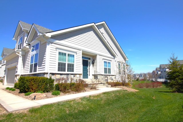 2667 Oxford Cir, Ann Arbor, MI 48103 - view of front of property featuring a front lawn, stone siding, and a residential view