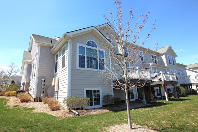2667 Oxford Cir, Ann Arbor, MI 48103 - rear view of house featuring a lawn and a wooden deck