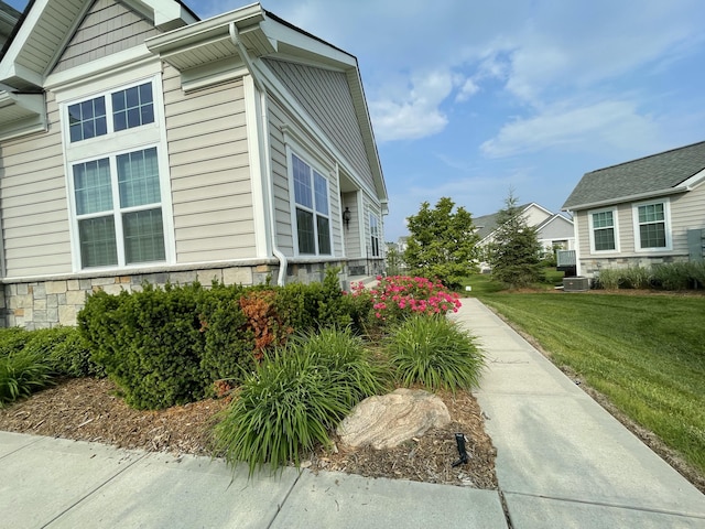 2667 Oxford Cir, Ann Arbor, MI 48103 - view of property exterior with stone siding and a yard