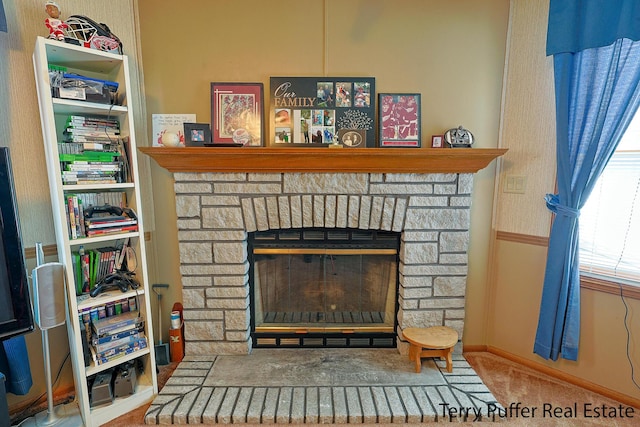 room details featuring carpet and a fireplace
