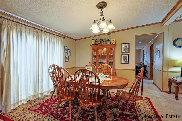 dining area with a textured ceiling, a notable chandelier, and crown molding