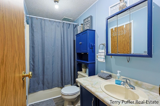 bathroom with toilet, shower / bath combo with shower curtain, vanity, and a textured ceiling