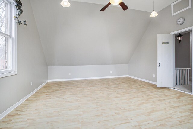 bonus room with visible vents, baseboards, wood finished floors, a ceiling fan, and vaulted ceiling