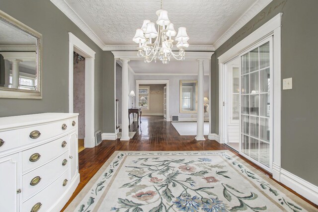 entrance foyer featuring ornamental molding, an ornate ceiling, baseboards, and ornate columns