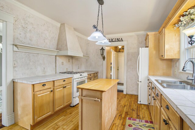 kitchen with light wood-style flooring, white appliances, wood counters, a sink, and custom range hood