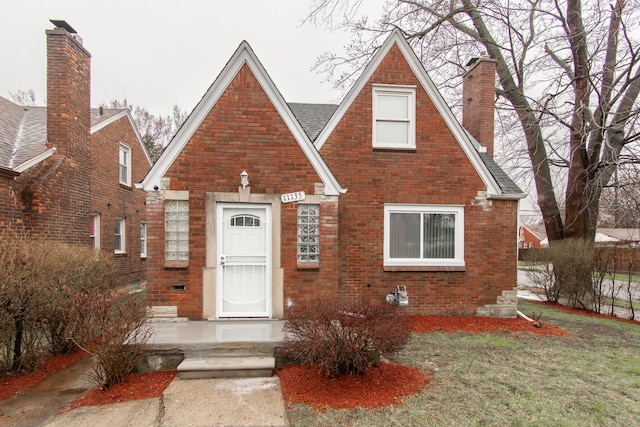 11135 Courville St, Detroit, MI 48224 - tudor-style house with brick siding and a chimney