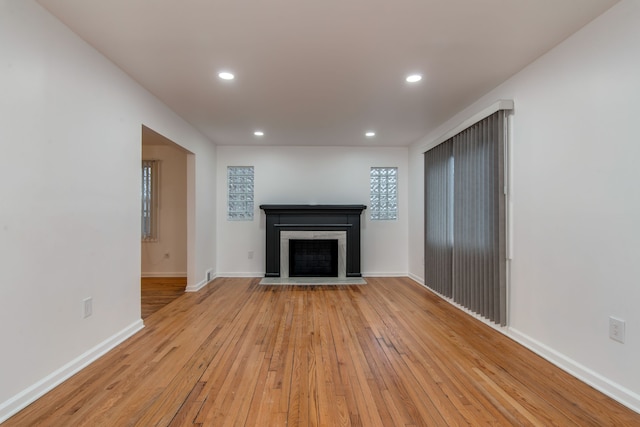 11135 Courville St, Detroit, MI 48224 - unfurnished living room featuring recessed lighting, baseboards, a fireplace, and light wood-type flooring
