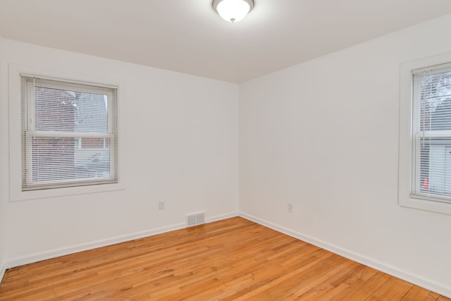 11135 Courville St, Detroit, MI 48224 - spare room featuring baseboards, visible vents, and light wood-type flooring