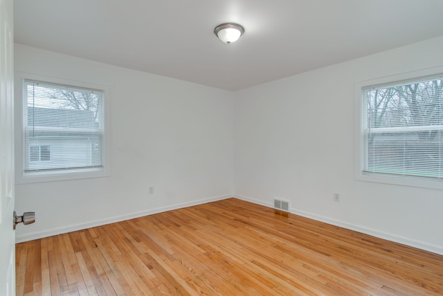 11135 Courville St, Detroit, MI 48224 - unfurnished room featuring baseboards, visible vents, light wood-style floors, and plenty of natural light