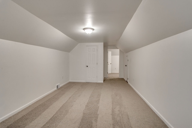 11135 Courville St, Detroit, MI 48224 - additional living space with baseboards, lofted ceiling, light colored carpet, and visible vents