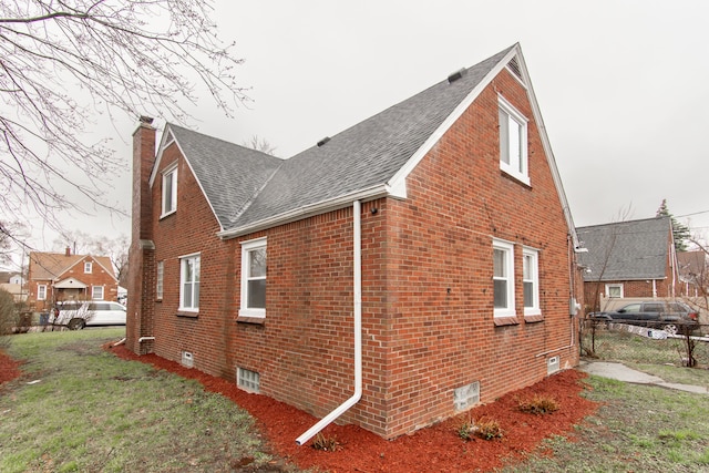11135 Courville St, Detroit, MI 48224 - view of side of property featuring roof with shingles, a chimney, fence, brick siding, and a yard