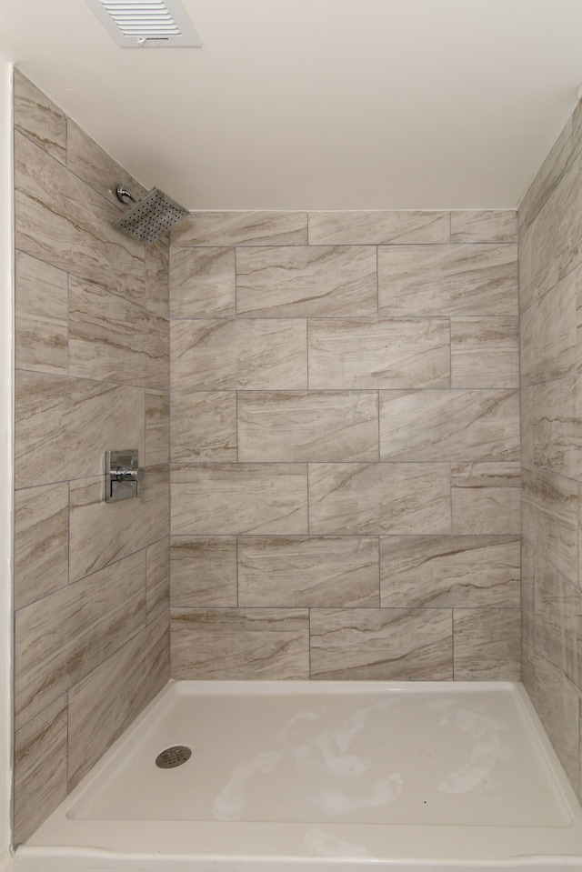 11135 Courville St, Detroit, MI 48224 - bathroom with visible vents and a tile shower