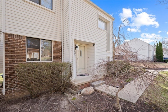property entrance with brick siding