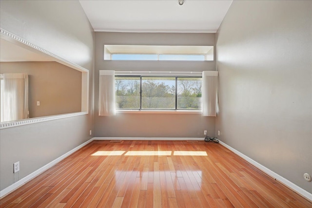empty room with wood finished floors and baseboards