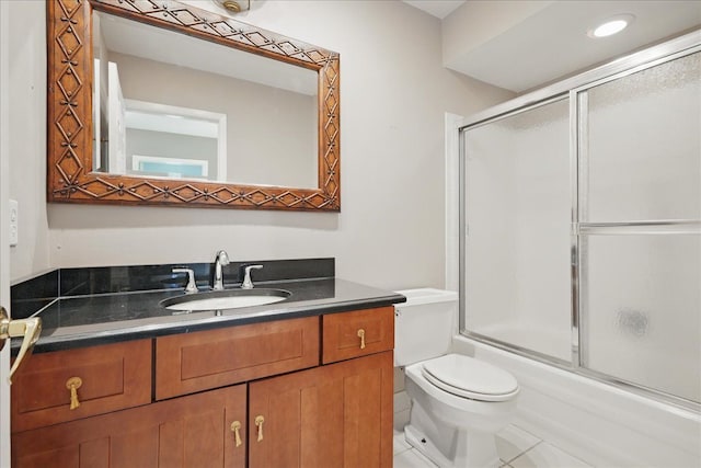full bath featuring vanity, toilet, and shower / bath combination with glass door