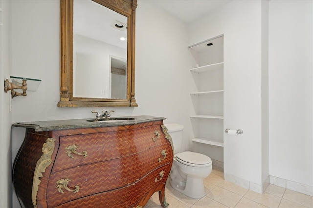 bathroom featuring toilet, tile patterned floors, and vanity