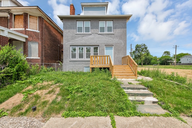 2916 Gladstone St, Detroit, MI 48206 - rear view of house featuring a chimney, brick siding, stairs, and a wooden deck