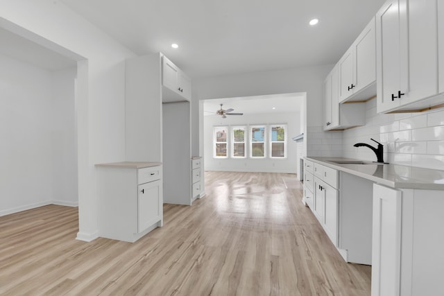 2916 Gladstone St, Detroit, MI 48206 - kitchen featuring backsplash, light wood-style flooring, a sink, and ceiling fan
