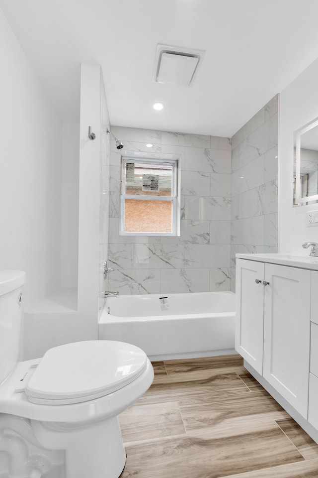 2916 Gladstone St, Detroit, MI 48206 - full bathroom featuring wood finished floors, toilet, vanity, and washtub / shower combination