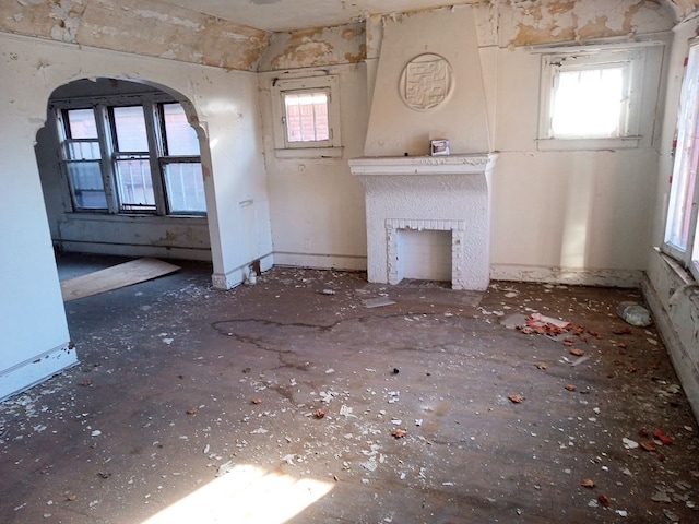 3741 Tyler St, Detroit, MI 48238 - unfurnished living room with arched walkways and a fireplace