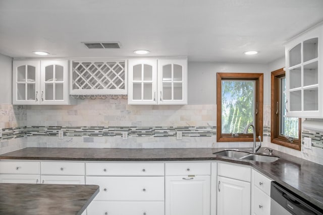 24199 N Shore Dr, Edwardsburg, MI 49112 - kitchen with a sink, tasteful backsplash, stainless steel dishwasher, glass insert cabinets, and white cabinets