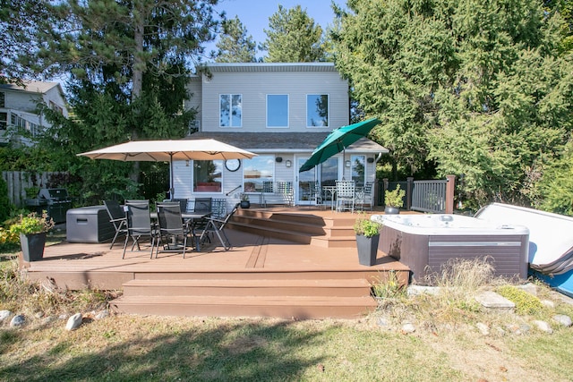 24199 N Shore Dr, Edwardsburg, MI 49112 - rear view of house with a jacuzzi, fence, outdoor dining area, and a deck