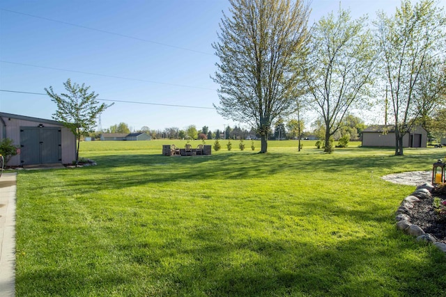 7042 Calkins Rd, Flint, MI 48532 - view of grassy yard with an outdoor structure and a storage unit